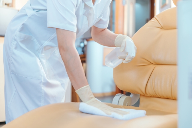 診療椅子を除菌・清掃するスタッフ
